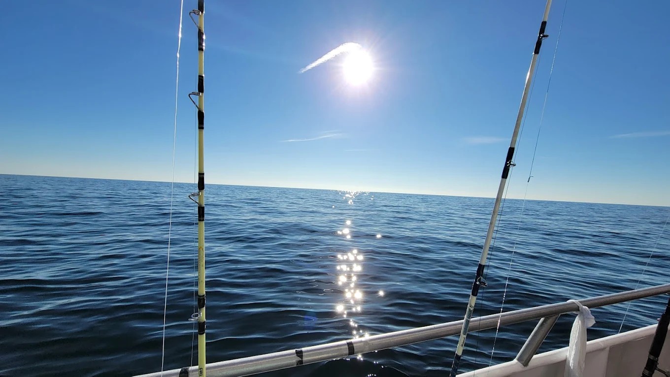 Family celebrating a striped bass catch aboard Super Hawk Fishing Charter in Point Lookout, NY