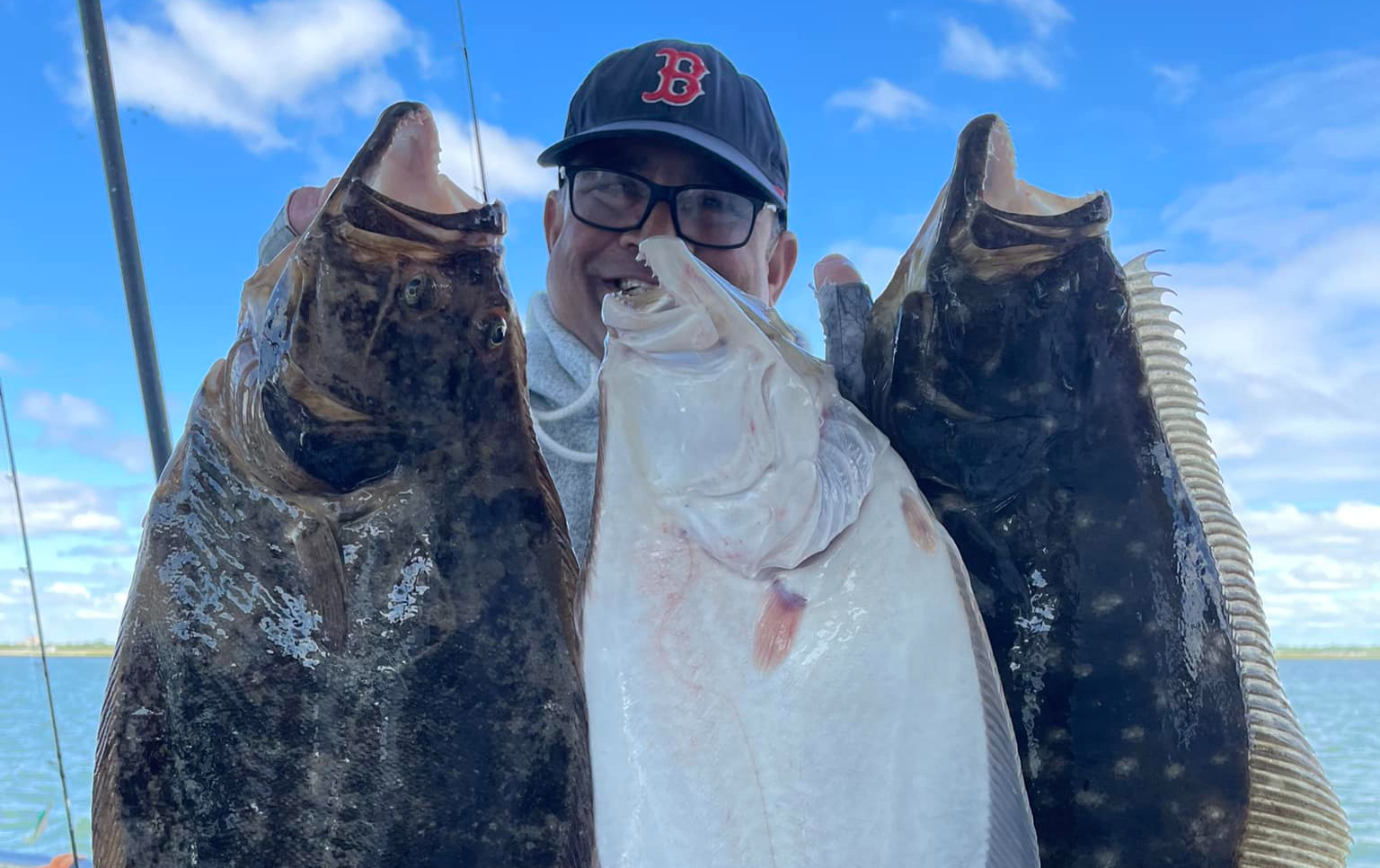 First-time anglers aboard a Long Island fishing boat in Point Lookout, NY — crew assisting with rod setup