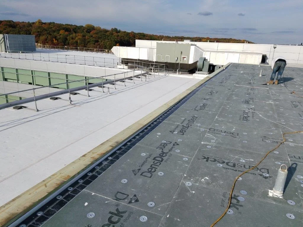 Flat roof drainage system repair by All-Star Roofing in the Amity Harbor commercial district, Suffolk County